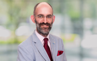 Richard Totty portrait photograph in front of blurred greenery office scene