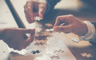 Insights - Mental Health Awareness - teamwork colleagues working together to complete a puzzle