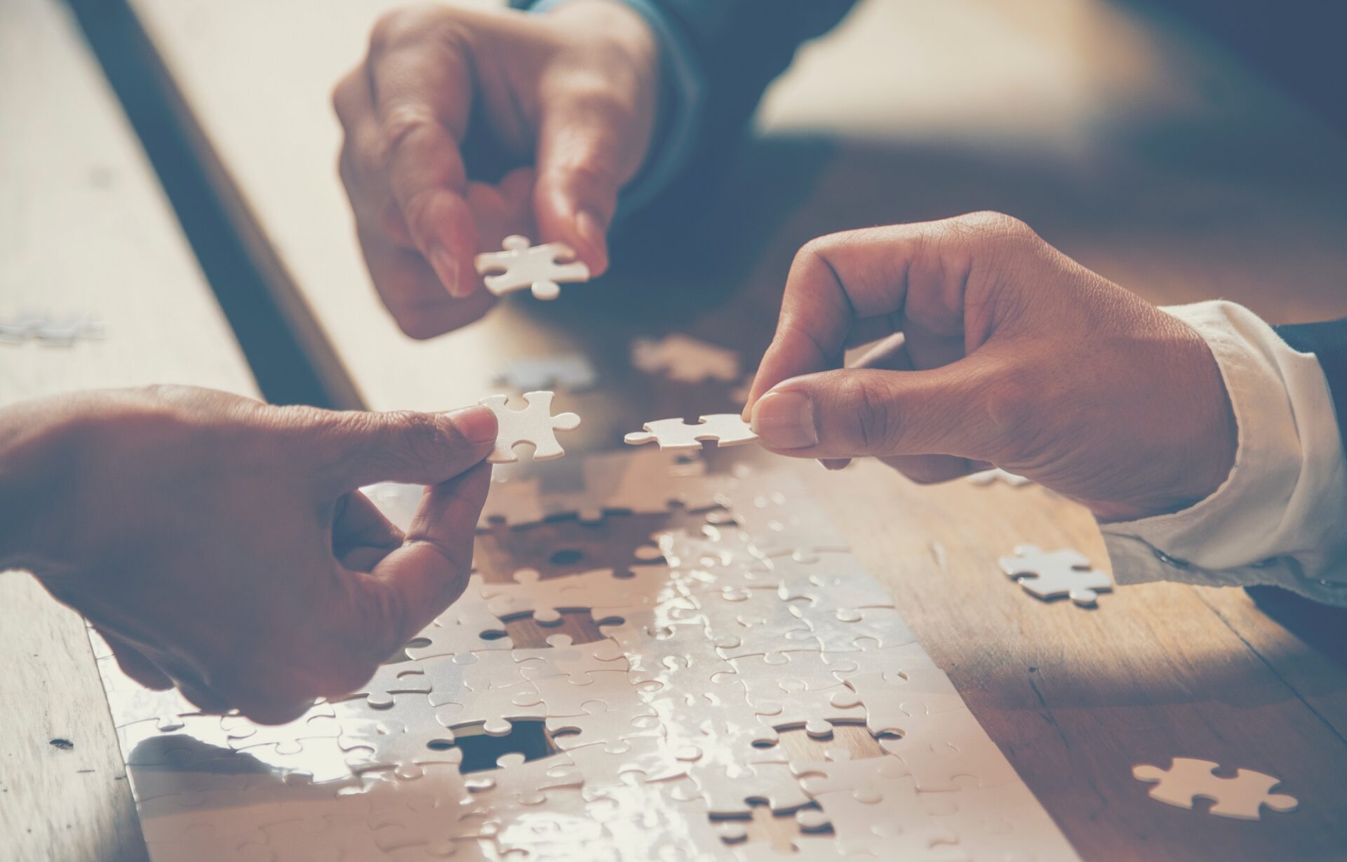 Insights – Mental Health Awareness – teamwork colleagues working together to complete a puzzle Insights - Mental Health Awareness - teamwork colleagues working together to complete a puzzle